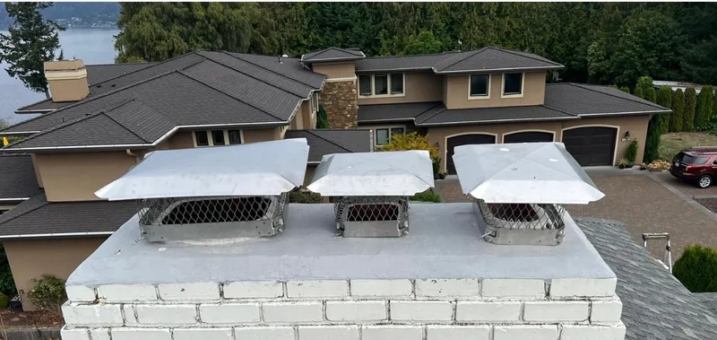 Multiple chimney caps installed on repaired chimney
