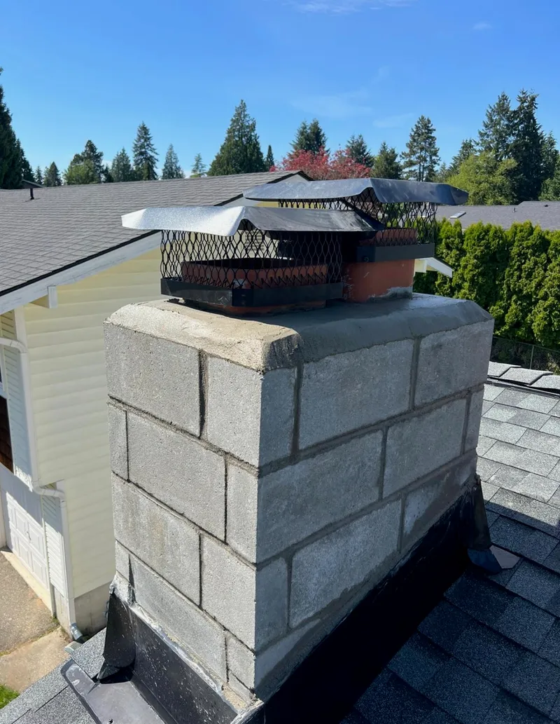 Finished chimney rebuild with protective caps installed