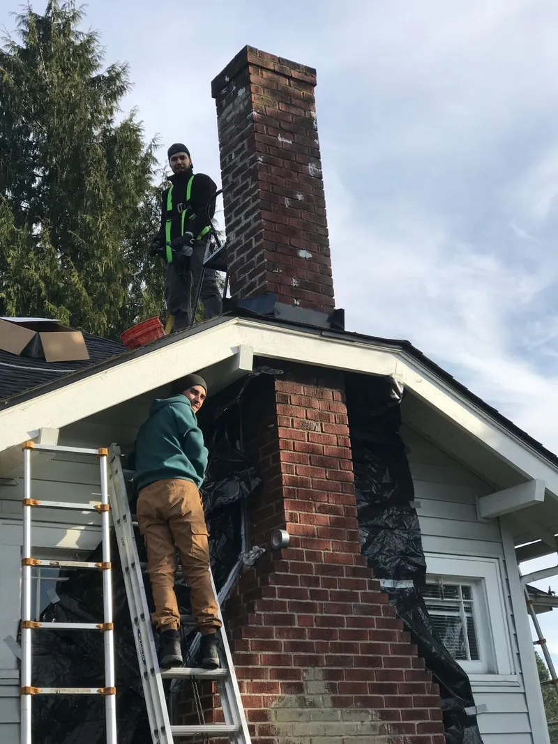 Seattle chimney repair specialists at work on a residential chimney