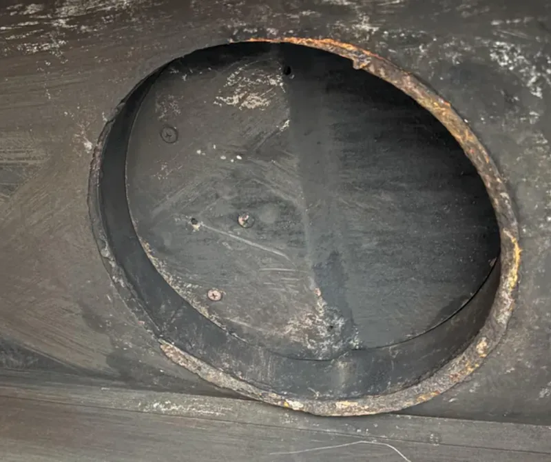 Rusted damper or firebox parts — chimney repair warning sign