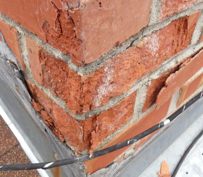 Spalling or flaking bricks — chimney repair warning sign